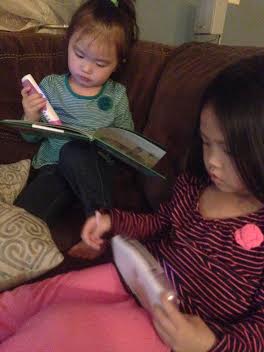 Anna and Grace playing with new Leap Frog gadgets from Aunt Beth and Uncle Kevin