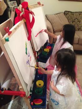 Anna and Grace painting on the easels Pops and Susu gave them