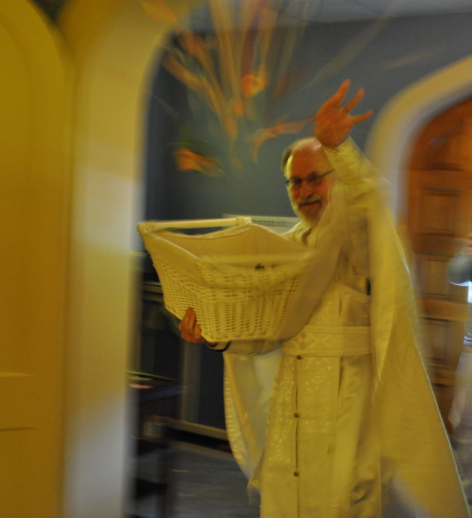 Father Basil tossing bay leaves on Holy Saturday