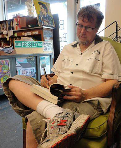 Corey signing at the bookstore he owns with his wife, Cheryl, Burke's Books in Memphis