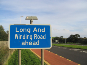 long_and_winding_road_ahead_sign_by_pudgemountain-d5uqpux
