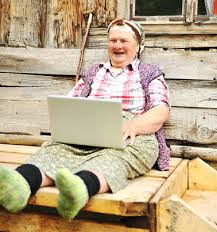 woman laughing w laptop