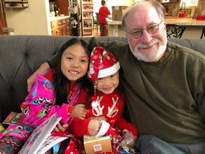 Pops getting ready to read A Guinea Pig Nativity to Grace and Anna