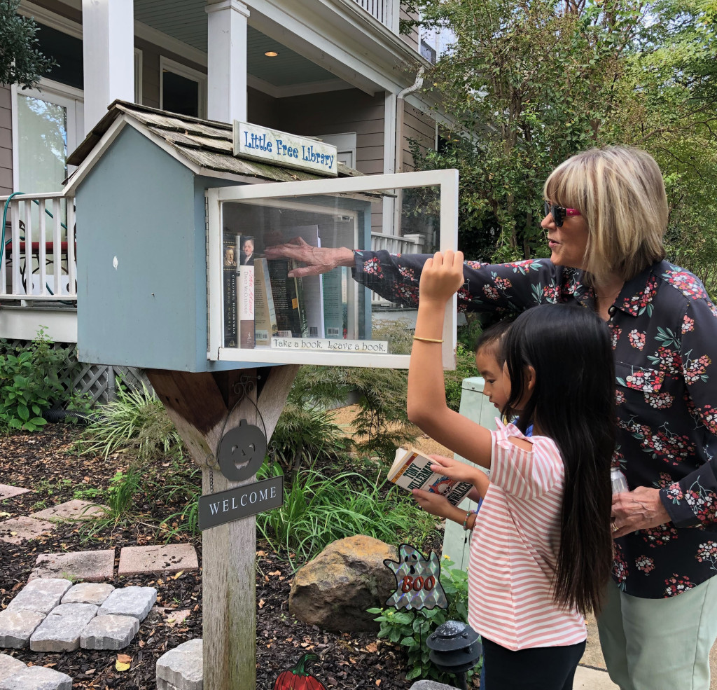 Grace, Anna, and SuSu visit one of the two Little Free Libraries in our neighborhood.