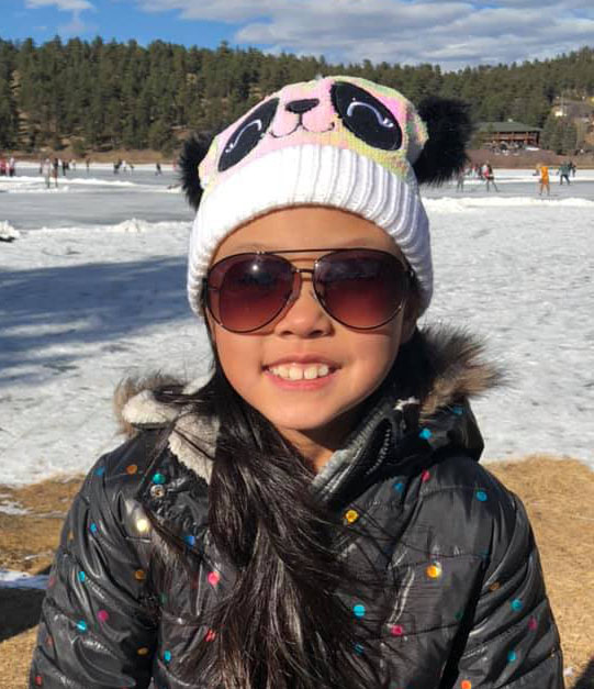 Grace on a frozen lake near her house outside Denver